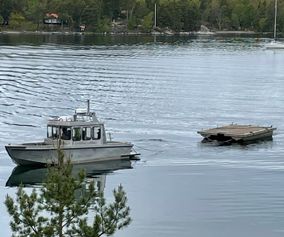Raft Frimärket home again after work at quay in Dalarö